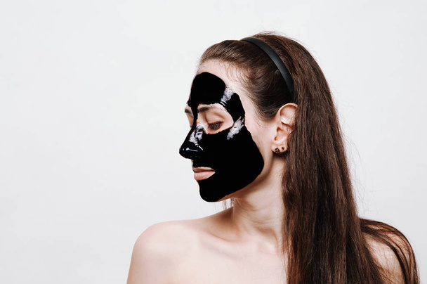 White young girl with black mask on white background. - Fotoğraf, Görsel