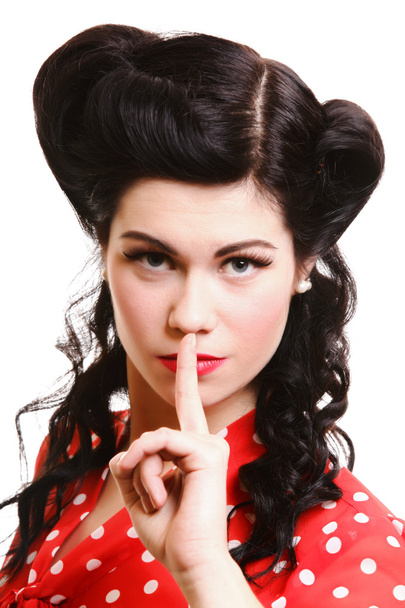 Pin-up girl finger near mouth silence gesture - Foto, afbeelding