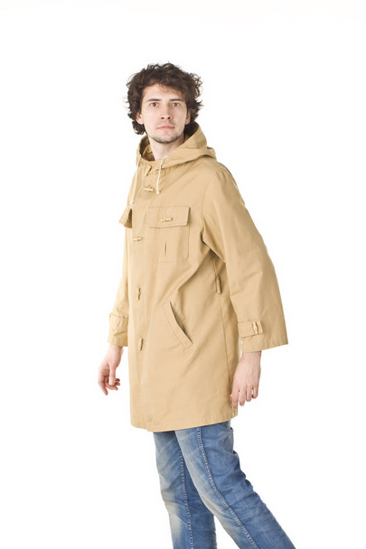 Nice man wearing in raincoat making a step - Photo, image