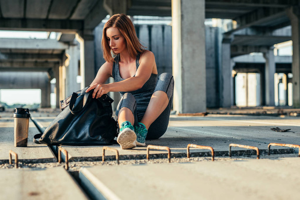 Portrait of an athlete woman getting ready for a workout outdoors. - Foto, Imagem