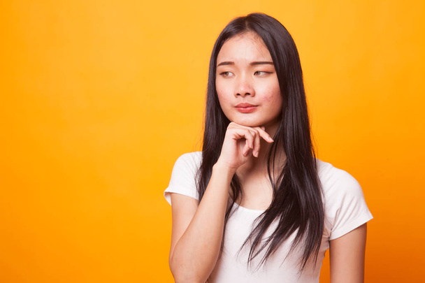 Serious  young Asian woman  look away on bright yellow background - Фото, зображення