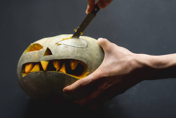 making a pumpkin jack o lantern with carved teeth for halloween concept d - 写真・画像