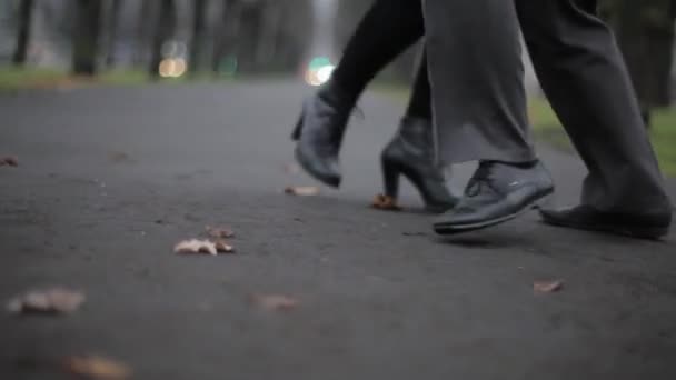 Mans and womans feet in black leather shoes move in dance on ground in street - Footage, Video