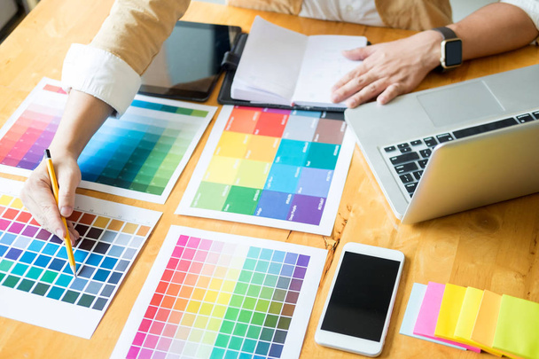 Creative Graphic designer at work. Color swatch samples pantone palette in studio modern office, interior design, renovation and technology concept - Photo, Image
