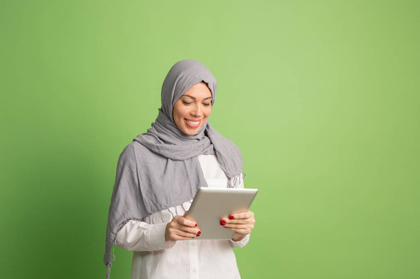 Happy arab woman in hijab. Portrait of smiling girl, posing at studio background - Photo, image