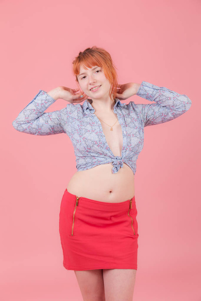 girl in a shirt and a skirt on a pink background - Photo, image