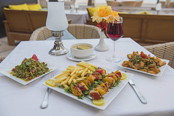 Primer plano de pollo shish tawook kebab comida en plato en restaurante de lujo al aire libre con aperitivos
 - Foto, imagen