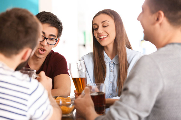 Group of cheerful friends drinking beer in bar - Foto, Imagem