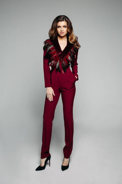 Fashionable model with brunette hair in bordo overall with desig - Foto, imagen
