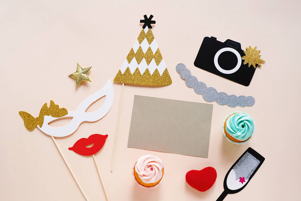 Flat lay of cute party props and cake with blank card on yellow background. Birthday, wedding party celebration - Zdjęcie, obraz