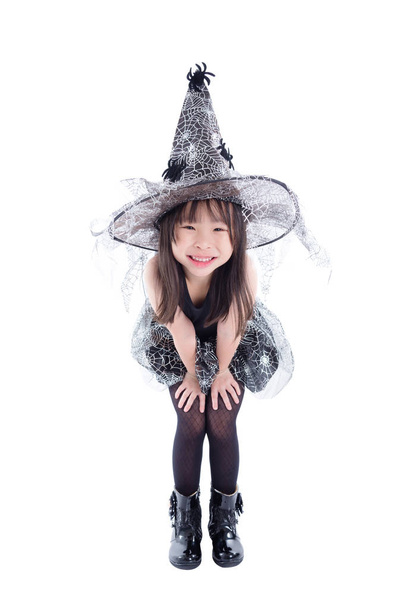 Full length of little asian girl wearing witch costume for Halloween isolated over white background - Photo, Image