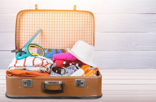 Retro suitcase with colorful clothes, travel concept - Zdjęcie, obraz