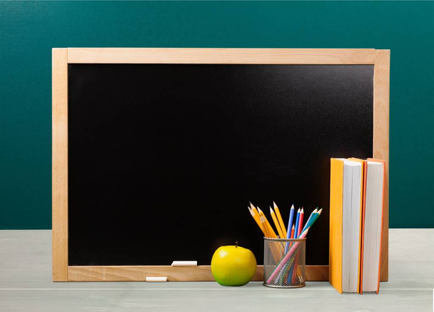 apple and pencils against blackboard, education background - Φωτογραφία, εικόνα