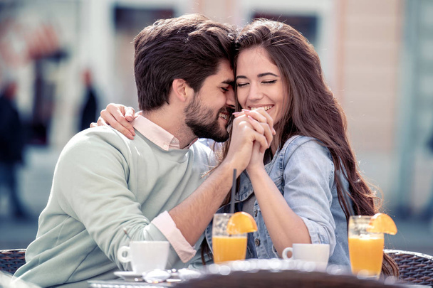 young couple sitting in cafe and enjoying conversation - Photo, Image