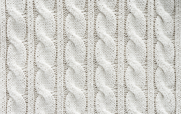 full frame of white knitted cloth with pattern as background - 写真・画像