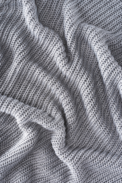 full frame of wavy grey knitted cloth as backdrop - Photo, Image
