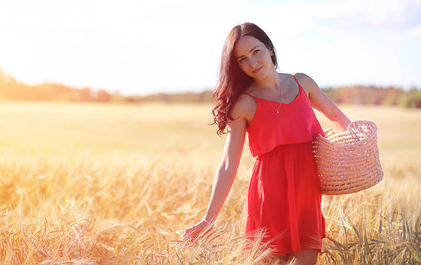 Young girl in a wheat field. Summer landscape and a girl on a na - Photo, Image