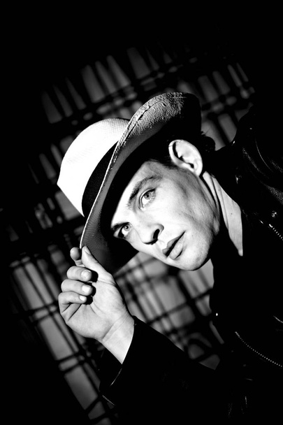 portrait of handsome male model in hat on dark studio background  - Valokuva, kuva