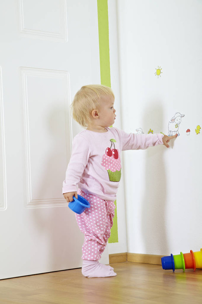 cute little baby having fun and playing with toy building blocks in nursery - Foto, Imagen