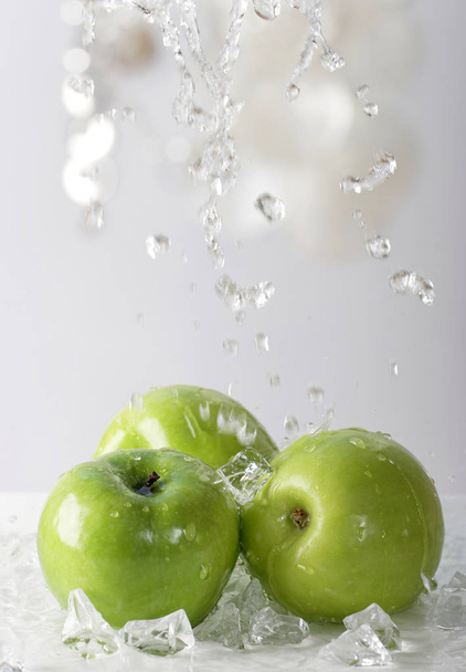 water pouring on pile of green apples, close-up   - Фото, зображення