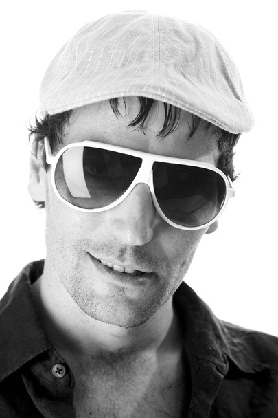portrait of handsome man in cap and sunglasses looking at camera isolated on white background, close-up  - Fotó, kép
