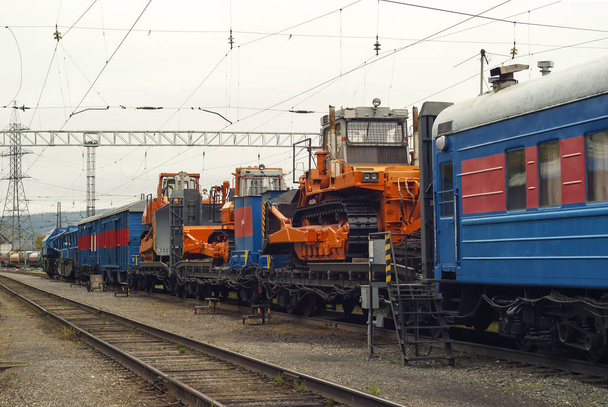 train for accident recovery work with heavy bulldozers on platforms is on the siding - Photo, Image