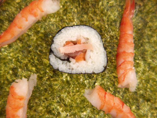 pile of sushi on green nori sheet , close-up  - 写真・画像