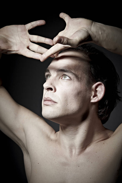 portrait of emotional naked man grimacing on dark background  - Fotoğraf, Görsel