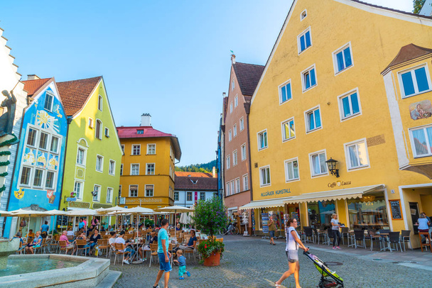FUSSEN, GERMANY - AUG 28, 2018: Street cafe in the Fussen old town city centre. Fussen is a small town in Bavaria, Germany. - Fotoğraf, Görsel