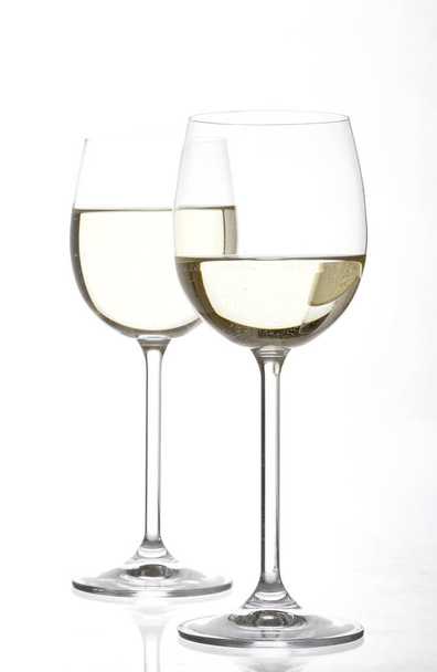 full of white wine wineglasses isolated on white background, close-up  - Photo, image
