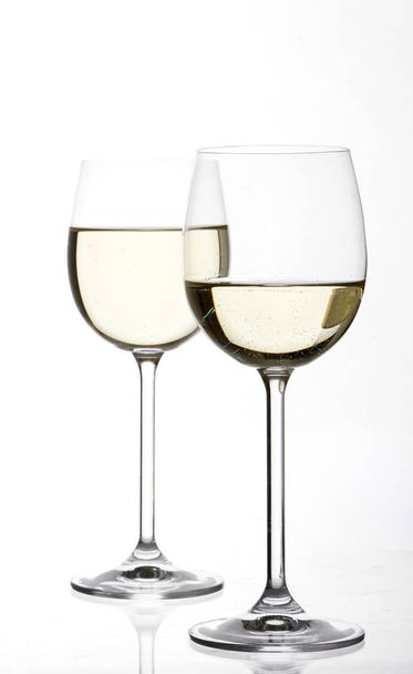 full of white wine wineglasses isolated on white background, close-up  - Fotografie, Obrázek