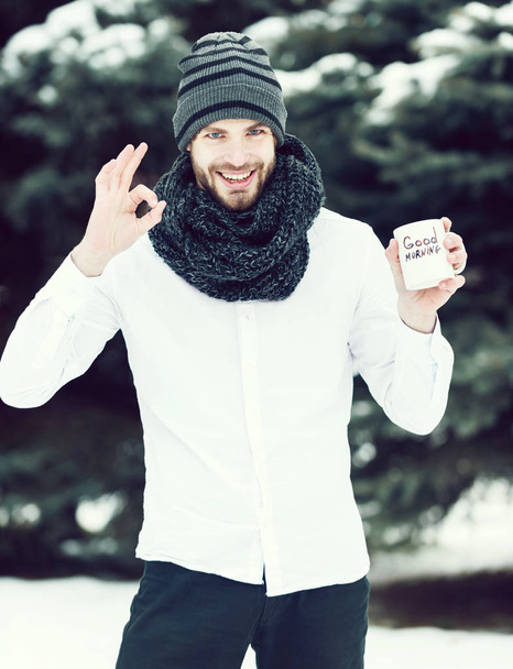 handsome man with morning cup in winter outdoor - Valokuva, kuva