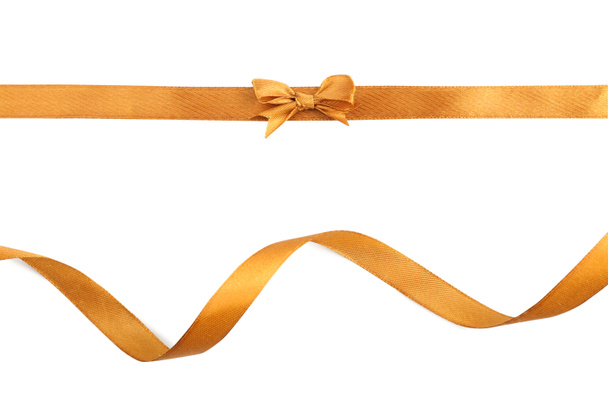Golden ribbons with beautiful bow on white background - Photo, Image