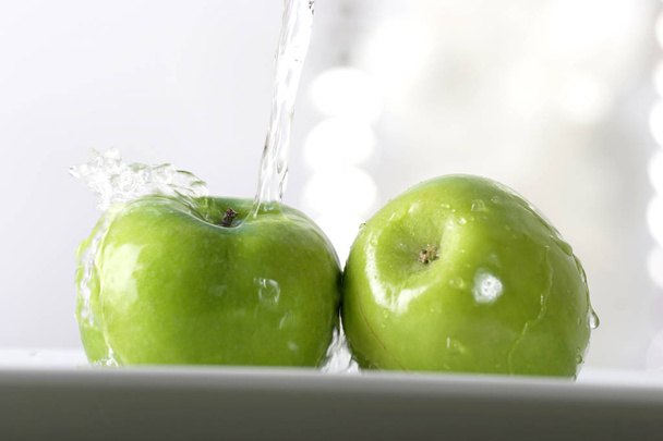 water pouring on ripe green apples, close-up   - Foto, Bild
