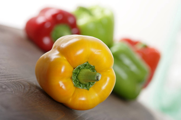 pile of colorful bell peppers on wooden background, close-up  - Foto, Bild