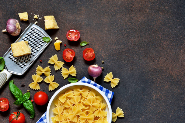 Food frame. Ingredients for pasta - cherry tomatoes, garlic, basil, Parmesan, top view. - Фото, изображение