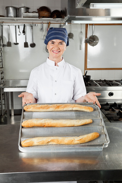 Female Chef Presenting Baked Loafs - Fotoğraf, Görsel