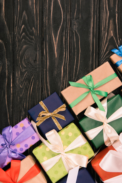 top view of wrapped christmas gifts on wooden surface - 写真・画像