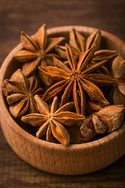 Anise star, close-up, fragrant spice, wooden background - Photo, Image