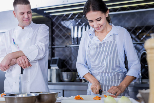 Attractive woman cooking a new dish in the kitchen - Photo, Image