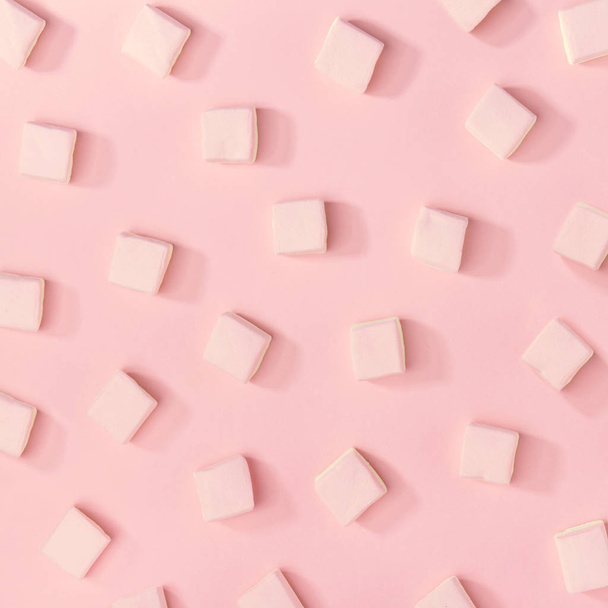 Top view of composed white sweet marshmallows on pink background. Pattern. Square picture - Photo, Image
