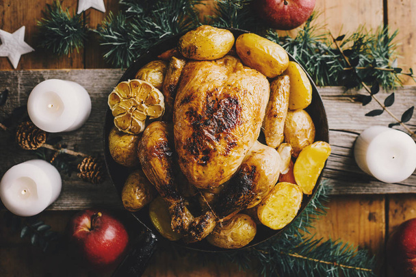 Christmas tasty chicken on pan on dinner table. Concept of Christmas dinner. View from above. - 写真・画像