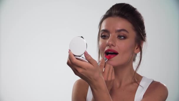 Lips Makeup. Beautiful Woman Applying Red Lipstick On Lip - Filmati, video