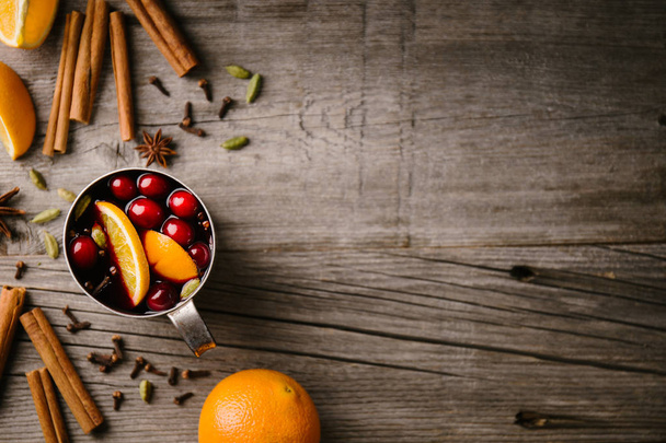 Tasty hot mulled wine with fruits in old vintage cup. Closeup, view from above. Horizontal with copy space  - Fotoğraf, Görsel