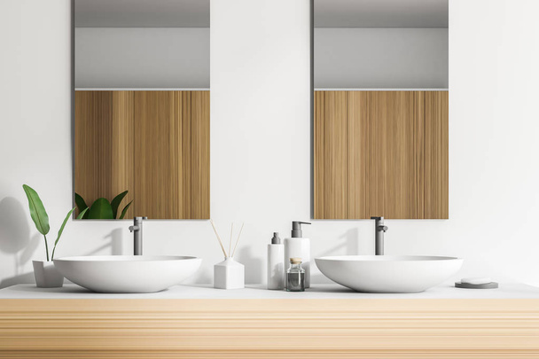Double sink on a wooden countertop with two vertical mirrors and a shelf with folded towels. White walls. Concept of luxury hotel or mansion. 3d rendering - Foto, Bild