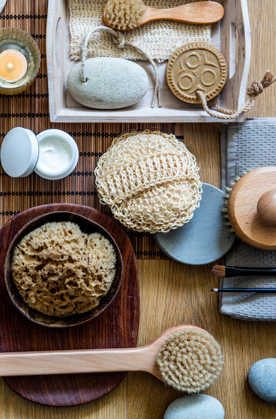 home spa concept with traditional body care objects for healthy shower with zero waste loofah, natural sponge, wooden brushes, skincare and makeup, above view - 写真・画像