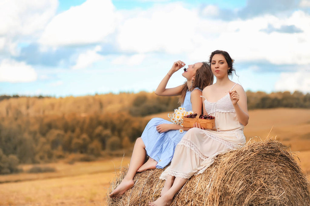 Deux filles en robes dans le champ d'automne
 - Photo, image