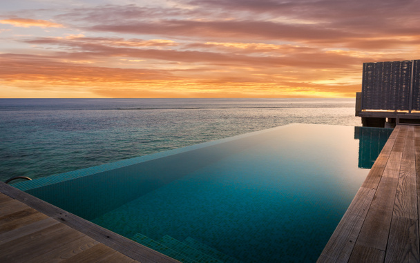 Private swimming pool and amazing sunset in Maldives - Photo, Image