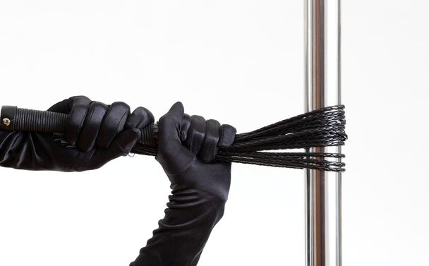 black gloves, whip and pole - Foto, afbeelding