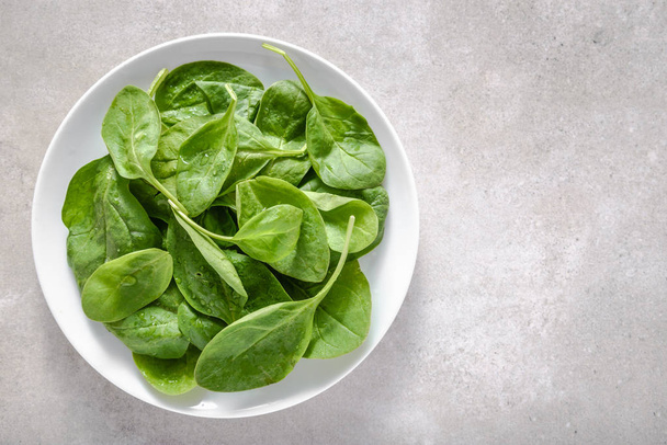 Green vegetables - spinach on plate, healthy food, vegetarian diet concept. - Φωτογραφία, εικόνα
